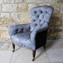 Load image into Gallery viewer, victorian-deep-button-back-upholstered-armchair-beautiful-shape-turned-legs-front-square-legs-rear-original-brass-castors-chair-professionally-re-upholstered-stunning-ludhiana-wool-fabric-intricate-decoration-inspiration-traditional-indian-patterns-swirling-floral-design-blue-cream-colourway-stylish-chair-elegant-design-english-late-victorian-damon-blandford-antiques-for-sale-the-malthouse-collective-stroud-gloucestershire-cotswolds-for-sale-antique-seating