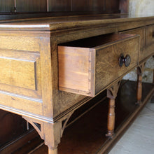Load image into Gallery viewer, welsh-dresser-and-&-rack-fabulous-original-sun-bleached-colour-rack-moulded-cornice-above-frieze-blacksmith-forged-iron-cup-hooks-over-three-shelves-base-three-drawers-equal-length-original-turned-wooden-drawer-pulls-inlaid-mother-pearl-decoration-ring-turned-supports-carved-spandrels-pot-board-raised-bracket-feet-dresser-originates-mid-wales-newtown-powys-circa-1810-incredibly-attractive-damon-blandford-antiques-for-sale-stroud-gloucestershire