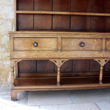 Load image into Gallery viewer, welsh-dresser-and-&-rack-fabulous-original-sun-bleached-colour-rack-moulded-cornice-above-frieze-blacksmith-forged-iron-cup-hooks-over-three-shelves-base-three-drawers-equal-length-original-turned-wooden-drawer-pulls-inlaid-mother-pearl-decoration-ring-turned-supports-carved-spandrels-pot-board-raised-bracket-feet-dresser-originates-mid-wales-newtown-powys-circa-1810-incredibly-attractive-damon-blandford-antiques-for-sale-stroud-gloucestershire