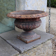 Load image into Gallery viewer, heavy-cast-iron-tazza-shaped-urn-fine-quality-fluted-body-heavy-square-pedestal-base-egg-dart-decoration-rim-wider-form-classical-shaped-urn-planter-beautifully-time-worn-finish-remnants-old-grey-red-paint-faded-pink-attractive-equally-well-suited-use-indoors-out-excellent-condition-english-circa-1860-damon-blandford-antiques-garden-decorative-home-for-sale-stroud-gloucestershire
