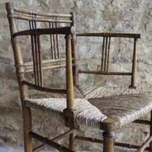 Load image into Gallery viewer, elegant-rush-seated-faux-bamboo-armchair-original-paint-backrest-constructed-two-top-bottom-rails-supporting-grouped-spindles-slender-proportions-arms-newly-woven-rush-seat-turned-legs-stretchers-painted-decoration-emulate-bamboo-retains-excellent-colour-enhanced-by-passage-time-use-aesthetically-beautiful-chair-incredibly-good-solid-example-condition-english-circa-1820-damon-blandford-antiques-for-sale-stroud-gloucestershire-cotswolds-interior-design-decoration