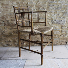 Load image into Gallery viewer, elegant-rush-seated-faux-bamboo-armchair-original-paint-backrest-constructed-two-top-bottom-rails-supporting-grouped-spindles-slender-proportions-arms-newly-woven-rush-seat-turned-legs-stretchers-painted-decoration-emulate-bamboo-retains-excellent-colour-enhanced-by-passage-time-use-aesthetically-beautiful-chair-incredibly-good-solid-example-condition-english-circa-1820-damon-blandford-antiques-for-sale-stroud-gloucestershire-cotswolds-interior-design-decoration