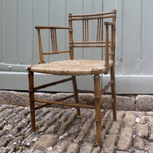 Load image into Gallery viewer, elegant-rush-seated-faux-bamboo-armchair-original-paint-backrest-constructed-two-top-bottom-rails-supporting-grouped-spindles-slender-proportions-arms-newly-woven-rush-seat-turned-legs-stretchers-painted-decoration-emulate-bamboo-retains-excellent-colour-enhanced-by-passage-time-use-aesthetically-beautiful-chair-incredibly-good-solid-example-condition-english-circa-1820-damon-blandford-antiques-for-sale-stroud-gloucestershire-cotswolds-interior-design-decoration