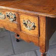 Load image into Gallery viewer, nicely-made-18th-century-provincial-oak-lowboy-three-oak-lined-drawers-cock-beading-original-brass-swan-neck-handles-pierced-back-plates-drawers-decoratively-carved-apron-a-particular-feature-of-this-tableall-raised-on-round-tapering-legs-pad-feet-excellent-colour-condition-north-england-1770-for-sale-damon-blandford-antiques-stroud-gloucestershire-country-house-furniture