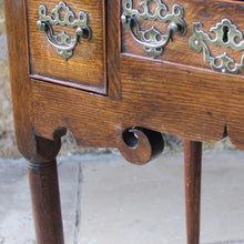 Load image into Gallery viewer, nicely-made-18th-century-provincial-oak-lowboy-three-oak-lined-drawers-cock-beading-original-brass-swan-neck-handles-pierced-back-plates-drawers-decoratively-carved-apron-a-particular-feature-of-this-tableall-raised-on-round-tapering-legs-pad-feet-excellent-colour-condition-north-england-1770-for-sale-damon-blandford-antiques-stroud-gloucestershire-country-house-furniture