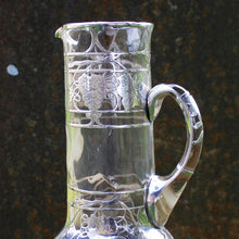 Load image into Gallery viewer, attractive-american-art-nouveau-riven-glass-claret-jug-silver-overlay-jug-cylindrical-form-small-lipped-spout-spread-base-c-scroll-handle-silver-overlay-intricate-design-featuring-grapes-vine-leaves-heart-shape-cartouche-exceptionally-good-quality-excellent-condition-turn-of-19th-20th-century-for-sale-damon-blandford-antiques-stroud-gloucestershire-cotswolds