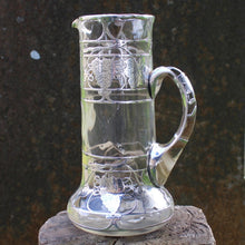 Load image into Gallery viewer, attractive-american-art-nouveau-riven-glass-claret-jug-silver-overlay-jug-cylindrical-form-small-lipped-spout-spread-base-c-scroll-handle-silver-overlay-intricate-design-featuring-grapes-vine-leaves-heart-shape-cartouche-exceptionally-good-quality-excellent-condition-turn-of-19th-20th-century-for-sale-damon-blandford-antiques-stroud-gloucestershire-cotswolds