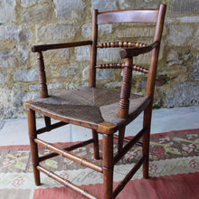 Load image into Gallery viewer, early-19th-century-rush-seated-open-armchair-excellent-quality-combining-carved-turned-details-shaped-bobbin-carved-mid-rails-shaped-top-rail-circular-styles-wonderfully-shaped-arm-rests-ring-turned-arm-supports-rush-seat-very-comfortable-chair-faux-bamboo-legs-stretchers-excellent-quality-condition-english-circa-1850s-for-sale-damon-blandford-antiques-stow-on-the-wold-stroud-cotswolds-gloucestershire-oxfordshire-interior-decor