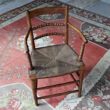 Load image into Gallery viewer, early-19th-century-rush-seated-open-armchair-excellent-quality-combining-carved-turned-details-shaped-bobbin-carved-mid-rails-shaped-top-rail-circular-styles-wonderfully-shaped-arm-rests-ring-turned-arm-supports-rush-seat-very-comfortable-chair-faux-bamboo-legs-stretchers-excellent-quality-condition-english-circa-1850s-for-sale-damon-blandford-antiques-stow-on-the-wold-stroud-cotswolds-gloucestershire-oxfordshire-interior-decor