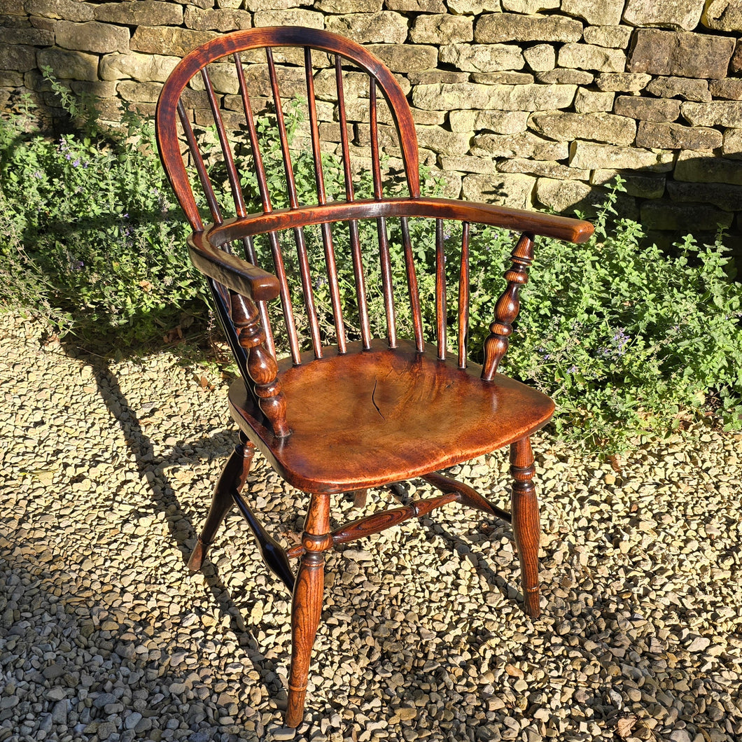 Lovely-colour-19th-century-windsor-arm-chair-low-hoop-stick-back-arm-rests-nicely-turned-supports-rare-alder-wood-saddled-seat-raised-on-turned-legs-h-shape-stretchers-design-north-east-or-thames-valley-areas-alder-shaped-comfortable-chair-excellent-condition-contemporary-period-settings-seating-for-sale-damon-blandford-antiques-stow-on-the-wold-cotswold-antiques