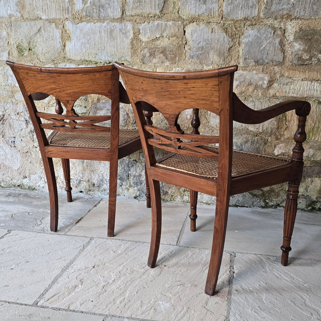 very-attractive-pair-19th-century-anglo-indian-colonial-armchairs-raffles-style-beautifully-hand-carved-teak-back-deep-shaped-crest-rails-scrolled-ends-reeded-mid-rails-down-swept-arms-baluster-shape-supports-caned-seats-fluted-legs-front-square-swept-legs-rear-attractive-comfortable-circa-1850-s-for-sale-damon-blandford-antiques-stow-on-the-wold