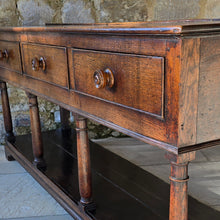 Load image into Gallery viewer, good-early-19th-century-welsh-oak-dresser-base-three-drawers-cock-beading-original-turned-wooden-drawer-pulls-apron-applied-moulded-edge-turned-supports-pot-board-bracket-feet-good-colour-excellent-condition-for-sale-damon-blandford-antiques-stow-on-the-wold-cotswolds
