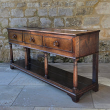 Load image into Gallery viewer, good-early-19th-century-welsh-oak-dresser-base-three-drawers-cock-beading-original-turned-wooden-drawer-pulls-apron-applied-moulded-edge-turned-supports-pot-board-bracket-feet-good-colour-excellent-condition-for-sale-damon-blandford-antiques-stow-on-the-wold-cotswolds
