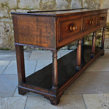 Load image into Gallery viewer, good-early-19th-century-welsh-oak-dresser-base-three-drawers-cock-beading-original-turned-wooden-drawer-pulls-apron-applied-moulded-edge-turned-supports-pot-board-bracket-feet-good-colour-excellent-condition-for-sale-damon-blandford-antiques-stow-on-the-wold-cotswolds
