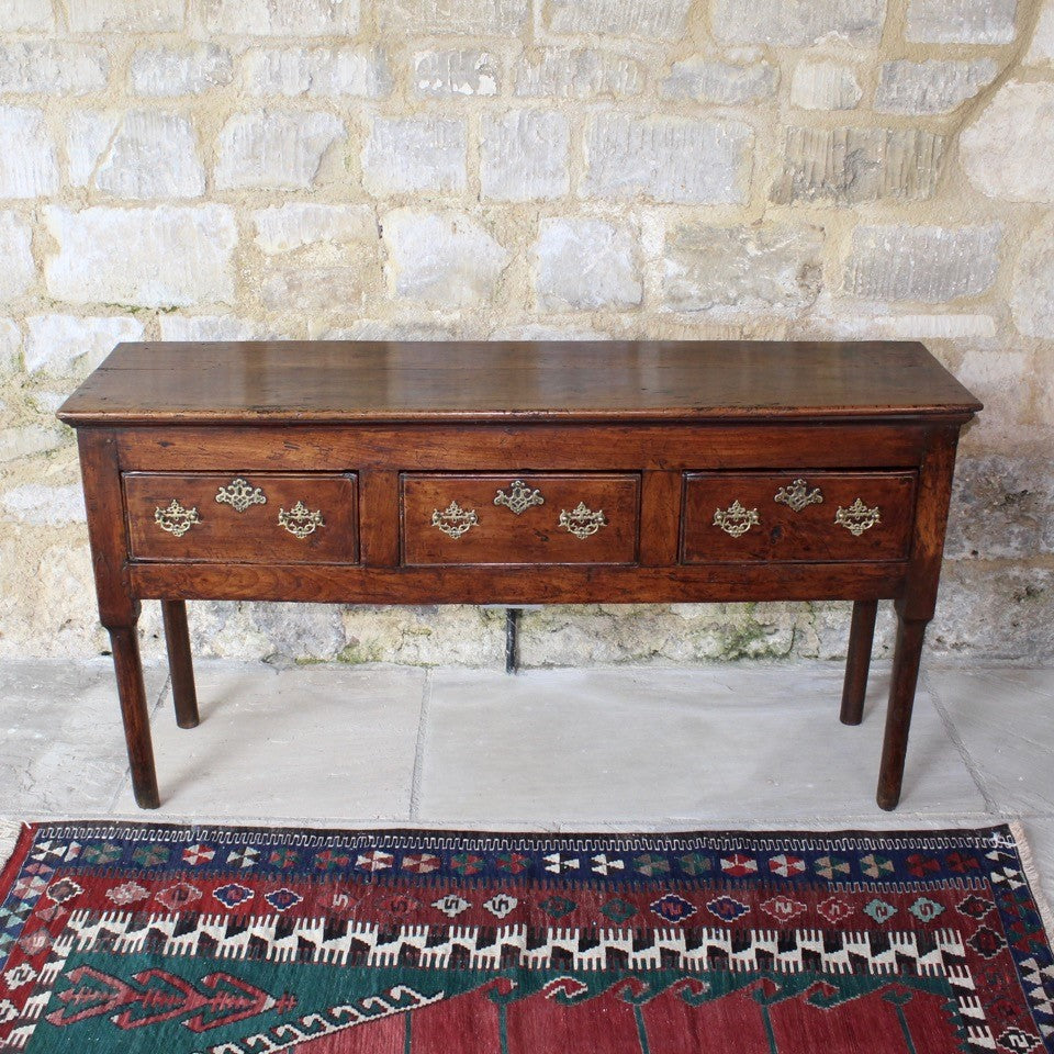 really-good-colour-provincial-cherrywood-serving-console-sofa-table-george-II-III-georgian-two-plank-top-applied-mouldings-three-drawers-rebated-butt-joint-construction-carved-cock-beading-pierced-brass handles-escutcheons-apron-panels-circular-tapered-legs-incredibly-attractive-table-fabulous-patination-good-usable-condition-time-worn-appearance-tremendous-aesthetic-appeal-small-proportions-northern-england-circa-1760-for-sale-damon-blandford-antiques-stow-on-the-wold-cotswolds-decorative-interiors-design