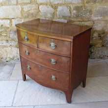 Load image into Gallery viewer, Attractive-early-19th-century-mahogany-bow-fronted-chest-of-drawers-bracket-feet-splayed at-foot-top-cross-banded-satinwood-stringing-two-short-two-long-drawers-cock-beading-drop-handles-drawers-lined-in-mahogany-fine-dovetailing-small-proportions-well-figured-veneer-particular-attractive-for-sale-damon-blandford-antiques-stroud-cotswolds-antique-storage
