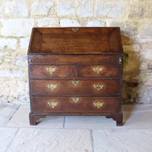 Load image into Gallery viewer, good-quality-18th-century-bureau-constructed-in-oak-fall-front-supported-by-two lopers-bearers-fitted-interior-nine-pigeon-holes-five-small-drawers-concealed-storage-well-two-short-two-long-drawers-dovetail-construction-brass-drop-handles-bracket-feet-highly-original-regional-furniture-excellent-condition-good-colour.-for-sale-damon-blandford-antiques-stow-on-the-wold-cotswolds-antique-strorage
