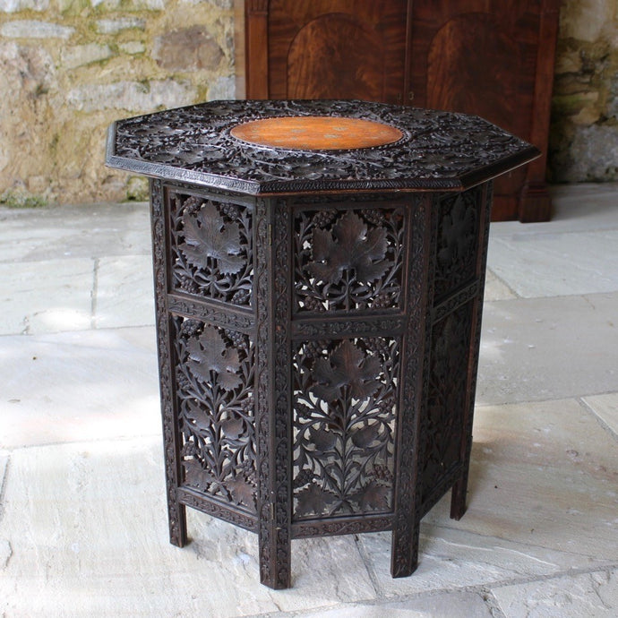 fine-late-19th-anglo-indian-octagonal-table-padauk-wood-decorative-brass-inlay-to-top-crisply-carved-fruit-and-foliage-highly-decorative-table-folding-flat-transportation-storage-highly-versatile-function-occasional-side-center-table-excellent-condition-circa-1890s-for-sale-damon-blandford-antiques-stow-on-the-wold-cotswolds