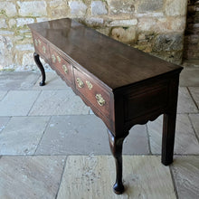 Load image into Gallery viewer, Excellent-quality-colour.mid-18th-century-oak-dresser-base-with-three-plank-top-moulded-edges-three-drawers- equal-length-plain-edges-brass-handles-escutcheons-fretwork-design-shapes-freeze-shapely-cabriole-legs-excellent-condition-for-sale-damon-blandford-antiques-cotswolds 
