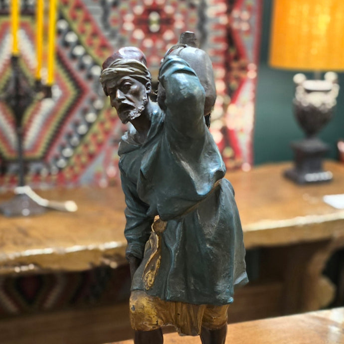 Spelter-casting-sculpture-north-african-moorish-water-carrier-late-19th-early-20th-century-polychrome-painted-spelter-figure-signed-original-ebonised-plinth-excellent-condition-good-colour-arab-male-traditional-clothing-carrying-water-vessel-steps-highly-decorative-interior-design-german-circa-1900-for-sale-damon-blandford-antiques-cotswolds-orientalist
