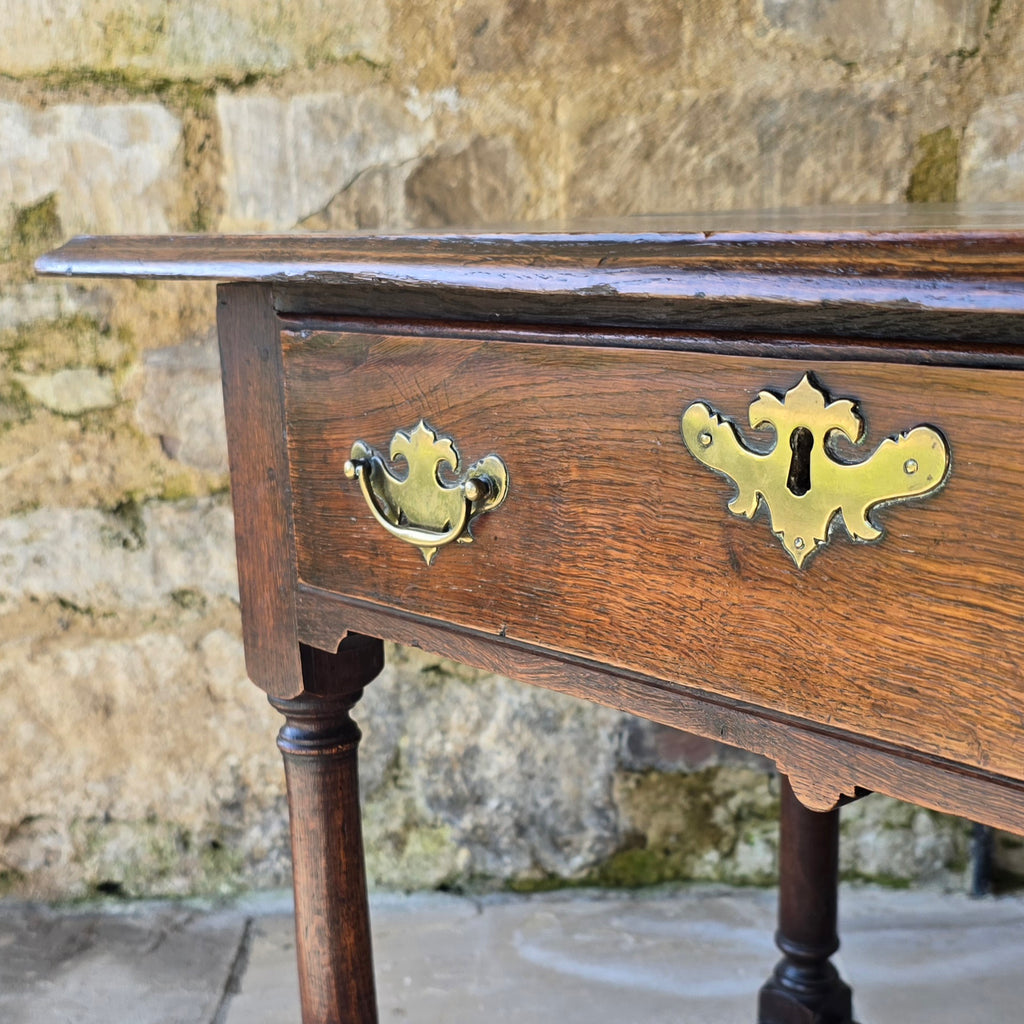 early-george-II-oak-side-table-exceptionally-good-colour-condition-overhung- top-ogee-moulding above-full-width-frieze-drawer-brass-handles-escutcheon-plate-well-turned-gun-barrel-legs-ring-turned-details-feet-outward-edged-stretches-english-circa-1730-for-sale-damon-blandford-antiques-stow-on-the-wold-cotswolds