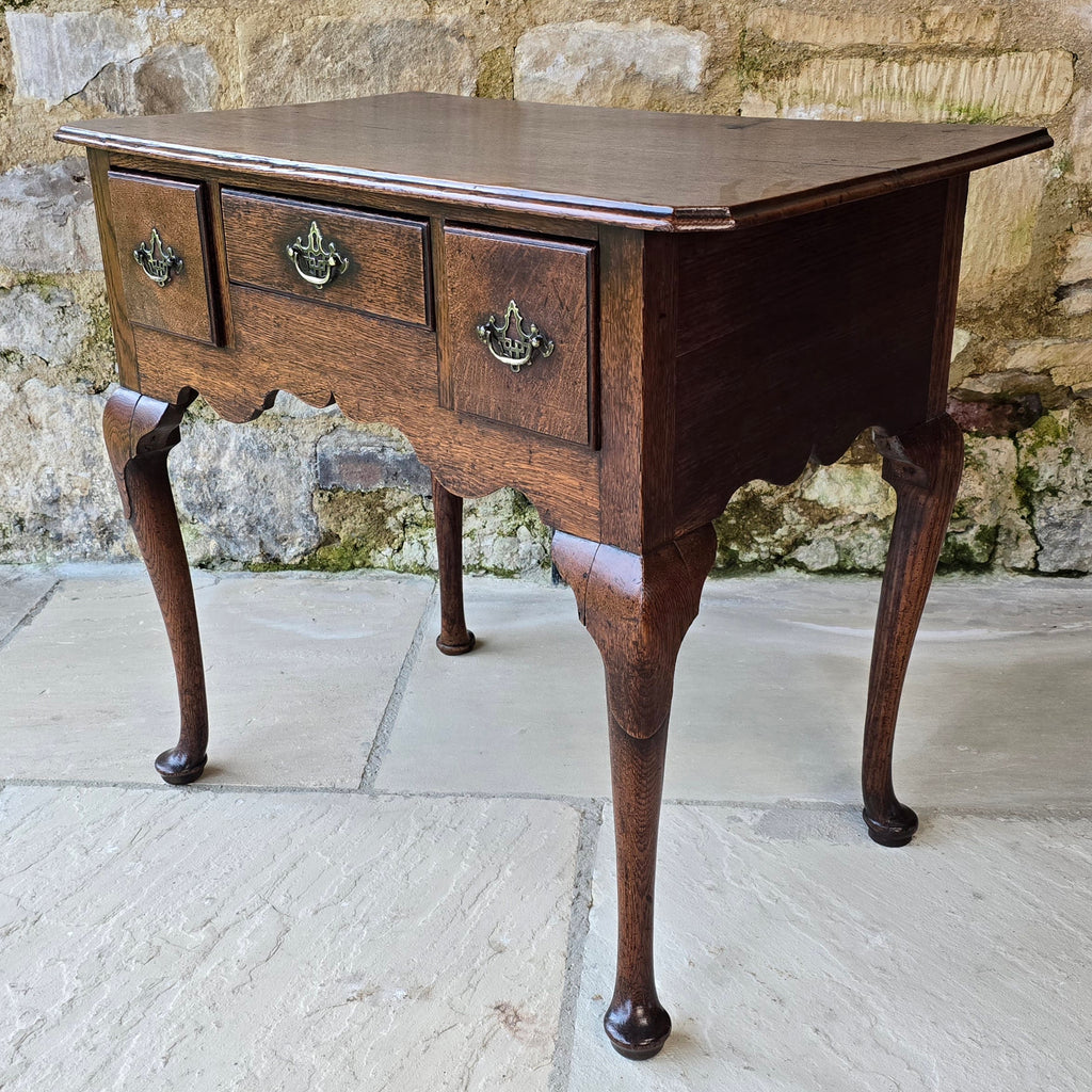Good-colour-early-georgian-oak-side-table-lowboy-three-overlapping-drawers-ovolo-mouldings-retaining-original-brass-handles-shaped-frieze-cabriole-legs-pad-feet-solid-stable-condition-honest-attractive-useful-english-circa-1720s-for-sale-damon-blandford-antiques-stow-on-the-wold-cotswolds