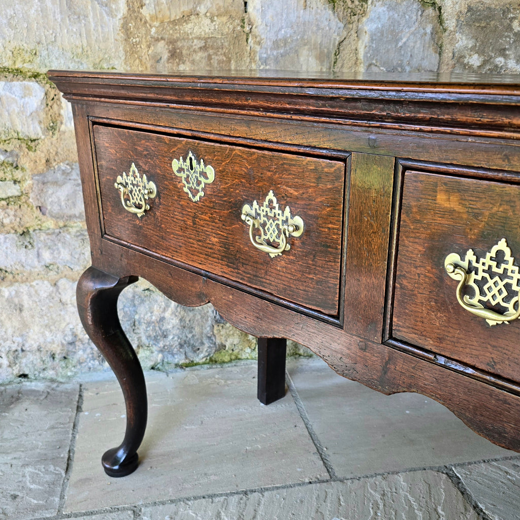 Excellent-quality-colour.mid-18th-century-oak-dresser-base-with-three-plank-top-moulded-edges-three-drawers- equal-length-plain-edges-brass-handles-escutcheons-fretwork-design-shapes-freeze-shapely-cabriole-legs-excellent-condition-for-sale-damon-blandford-antiques-cotswolds 