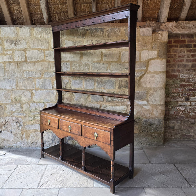 good-colour-georgian-welsh-oak-dresser-with-rack-constructed-from-well-figured-timbers-dresser-comprises-three-drawers-above-cupids-bow-shap- frieze-turned-supports-pot-board-excellent-condition-fresh-to-market-attractive-useful-furniture-south-wales-circa-1790-1810-good-original-condition-for-sale-damon-blandford-antiques-stow-on-the-wold