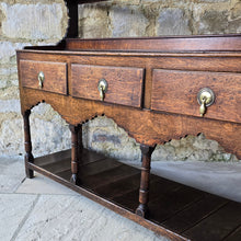 Load image into Gallery viewer, good-colour-georgian-welsh-oak-dresser-with-rack-constructed-from-well-figured-timbers-dresser-comprises-three-drawers-above-cupids-bow-shap- frieze-turned-supports-pot-board-excellent-condition-fresh-to-market-attractive-useful-furniture-south-wales-circa-1790-1810-good-original-condition-for-sale-damon-blandford-antiques-stow-on-the-wold

