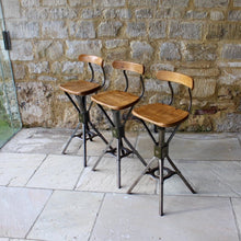 Load image into Gallery viewer, Three early Evertaut industrial stools with elm seats and back rests
