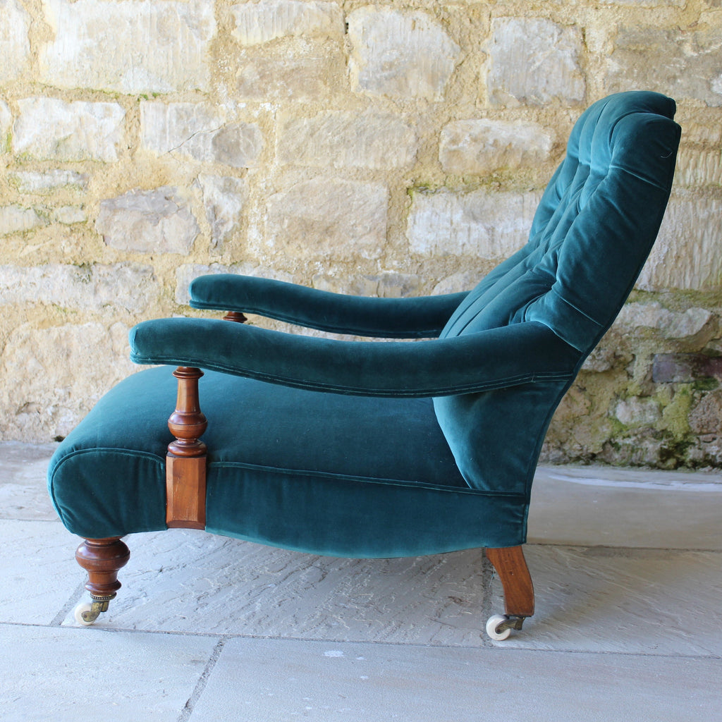Low deep seated Victorian open armchair in the style of James Shoolbred