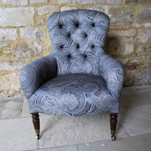 Load image into Gallery viewer, victorian-deep-button-back-upholstered-armchair-beautiful-shape-turned-legs-front-square-legs-rear-original-brass-castors-chair-professionally-re-upholstered-stunning-ludhiana-wool-fabric-intricate-decoration-inspiration-traditional-indian-patterns-swirling-floral-design-blue-cream-colourway-stylish-chair-elegant-design-english-late-victorian-damon-blandford-antiques-for-sale-the-malthouse-collective-stroud-gloucestershire-cotswolds-for-sale-antique-seating
