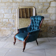 Load image into Gallery viewer, incredibly-attractive-victorian-button-back-upholstered-armchair-show-wood-frame-cabriole-legs-brass-castors-porcelain-wheels-excellent-condition-professionally-re-upholstered-teal-colour-velvet-generous-proportions-shaped-back-rest-comfortably-stylish-useful-damon-blandford-antiques-C19th-century-seating-for-sale-stroud-gloucestershire-cotswolds-interior-home-decor-design-louis-phillipe-mirror
