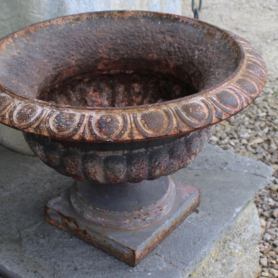 heavy-cast-iron-tazza-shaped-urn-fine-quality-fluted-body-heavy-square-pedestal-base-egg-dart-decoration-rim-wider-form-classical-shaped-urn-planter-beautifully-time-worn-finish-remnants-old-grey-red-paint-faded-pink-attractive-equally-well-suited-use-indoors-out-excellent-condition-english-circa-1860-damon-blandford-antiques-garden-decorative-home-for-sale-stroud-gloucestershire