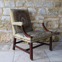 Load image into Gallery viewer, good-18th-century-english-georgian-library-gainsborough-chair-generous-proportions-long-term-private-ownership-square-shaped-back-flanked-upholstered-arms-concave-shaped-mahogany-arm-supports-seat-raised-square-moulded-legs-united-H-shape-stretchers-terminating-original-barrel-castors-covered-19th-century-needlepoint-fabric-french-very-usable-heavily-worn-velvet-country-house-chair-look-english-george-III-Circa-1790-damon-blandford-antiques
