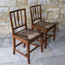 Load image into Gallery viewer, incredibly-elegant-pair-rush-seated-elm-side-chairs-back-rest-constructed-square-tapered-styles-slim-rails-slats-carved-split-splat-rush-seat-raised-slim-square-tapered-legs-front-square-gently-swept-legs-rear-all-united-stretchers-chairs-light-golden-colour-consistent-with-age-use-wonderful-aesthetic-quality-sturdy-stylish-useful-traditional-contemporary-settings-damon-blandford-antiques-stroud-gloucestershire-cotswolds-for-sale-seatinginterior-design-decor-arts-crafts-provincial-east-anglia
