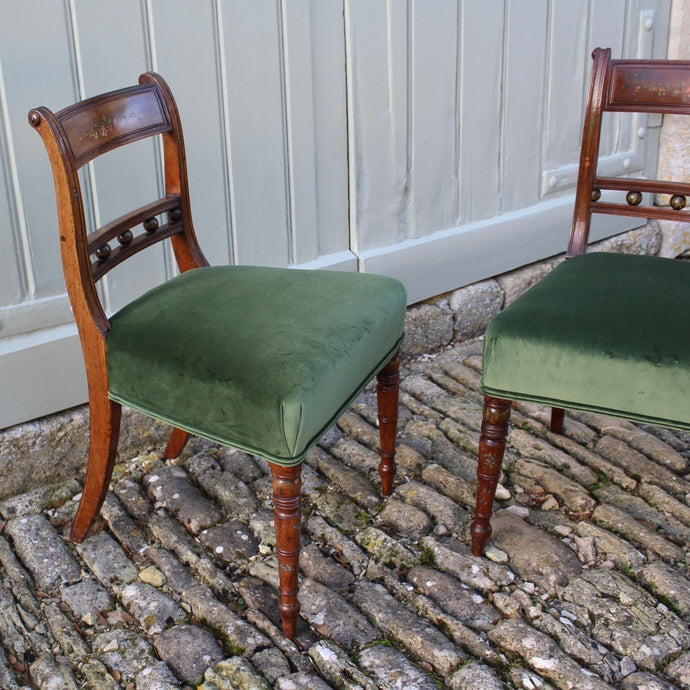 really-attractive-pair-late-georgian-chairs-retaining-original-painted-decoration-back-rest-square-swept-horizontal-cross-rails-ball-decoration-wider-top-rail-upholstered-seat-raised-turned-front-legs-square-swept-legs-rear-hand-painted-decoration-seat-pad-rebuilt-newly-re-upholstered-stive chairage-green-velvet-good-solid-condition-wonderful-english-circa-1800-damon-blandford-antiques-for-sale-seating-stroud-gloucestershire