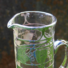 Load image into Gallery viewer, attractive-american-art-nouveau-riven-glass-claret-jug-silver-overlay-jug-cylindrical-form-small-lipped-spout-spread-base-c-scroll-handle-silver-overlay-intricate-design-featuring-grapes-vine-leaves-heart-shape-cartouche-exceptionally-good-quality-excellent-condition-turn-of-19th-20th-century-for-sale-damon-blandford-antiques-stroud-gloucestershire-cotswolds

