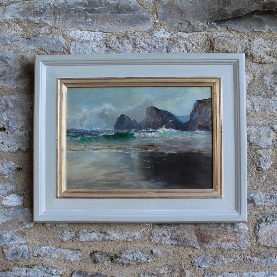 well-executed-oil-painting-board-aves-mid-ground-sand-foreground-backwash-breaking-waves-sunlight-stark-contrast-cloudy-sky-distant-coastline-rocky-outcrop-sea-atmospheric-painting-waves-movement-backwash-painting-signed-artist-name-address-labelverso-originally-bespoke-carefully-handmade-master-frame-maker-gilder-frame-finished-gesso-paint-gilding-process-colours-new-frame-original-painting-cornish-english-circa-1930-wall-art-damon-blandford-antiques-seascape-for-sale-ruan-minor-cornwall